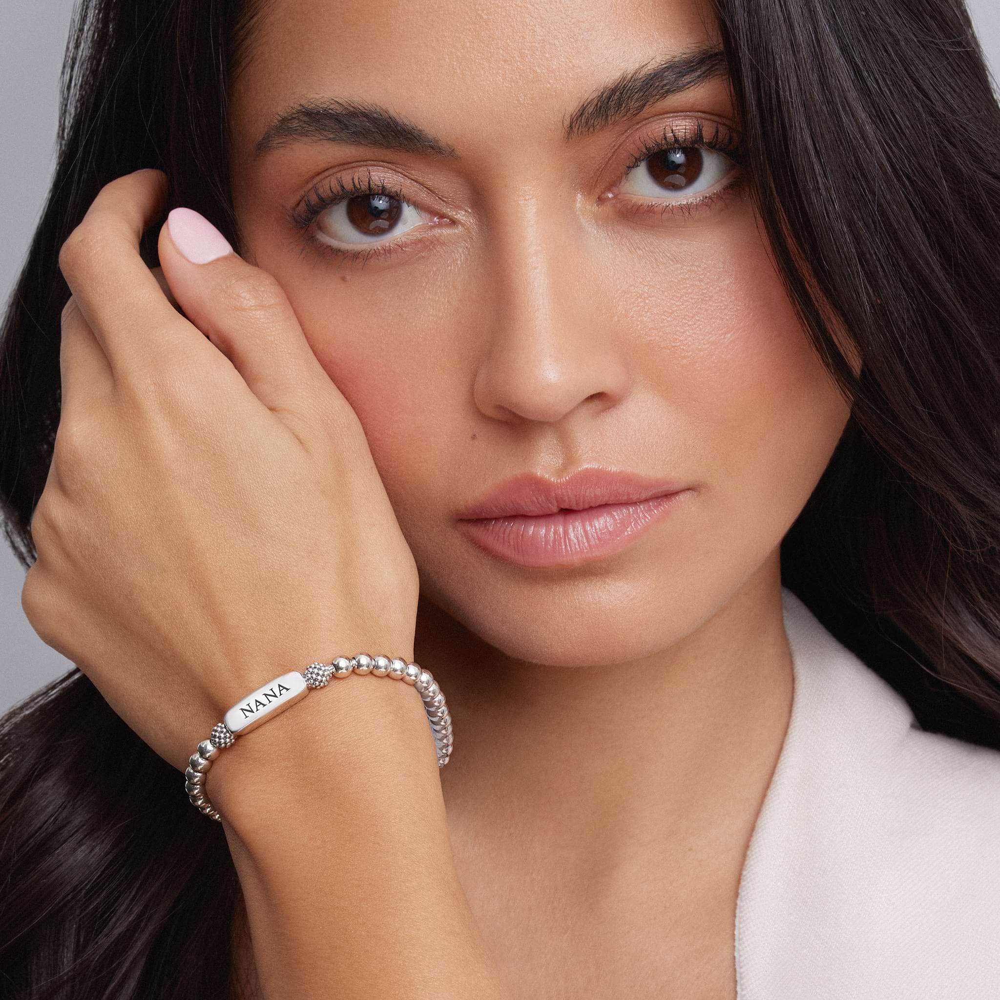 Woman wearing a Stretch Bead Bracelet with NANA engraved
