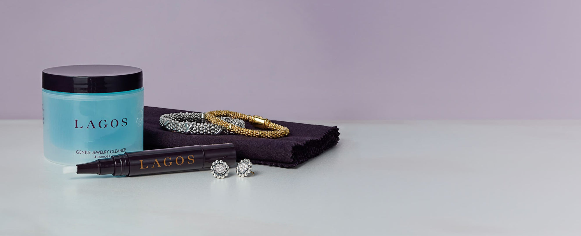 jewelry cleaner solution and pen withtwo bracelets and earrings